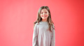 Portrait Of Girl Against Red Studio Background Smiling At Camera - PhotoDune Item for Sale