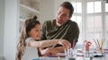Daughter At Home With Father Having Fun Doing Craft Together - PhotoDune Item for Sale