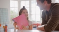 Daughter At Home With Father Having Fun Doing Craft Making Card Together - PhotoDune Item for Sale