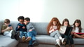 Group Of Boys And Girls Gaming Together On Hand Held Devices At Home - PhotoDune Item for Sale