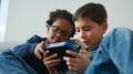 Two Boys Gaming Together On Hand Held Device At Home - PhotoDune Item for Sale