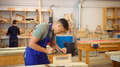 Male Student Studying For Carpentry Apprenticeship At College Using Wood Plane - PhotoDune Item for Sale
