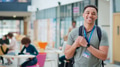 Portrait Of Smiling Male College Student In Busy Communal Campus Building - PhotoDune Item for Sale