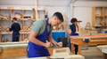 Male Student Studying For Carpentry Apprenticeship At College Using Wood Plane - PhotoDune Item for Sale