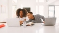 Adult Son And Teenage Daughter Using Laptops At Home Together - PhotoDune Item for Sale
