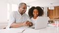 Teenage Girl Helping Grandfather To Use Laptop At Home - PhotoDune Item for Sale