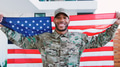 Portrait Of Male Soldier In Uniform Visiting Home On Leave Holding Stars And Stripes Flag - PhotoDune Item for Sale