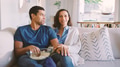 Couple Sitting On Sofa Watching TV And Eating Popcorn Together - PhotoDune Item for Sale