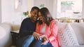 Loving Mature Couple Sitting On Sofa At Home Together - PhotoDune Item for Sale