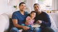 Male Multi Generation Family Sitting On Sofa At Home With Popcorn Watching TV Together - PhotoDune Item for Sale