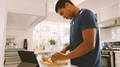 Man In Kitchen Preparing Meal Following Online Recipe On Digital Tablet - PhotoDune Item for Sale