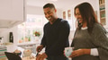 Mature Couple In Kitchen Preparing Meal With Man Following Online Recipe On Digital Tablet - PhotoDune Item for Sale