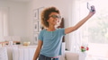 Girl Wearing Glasses Posing For Selfie On Mobile Phone In Lounge At Home - PhotoDune Item for Sale