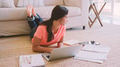 Young Girl Lying On Floor in Lounge At Home Doing Homework Using Laptop - PhotoDune Item for Sale