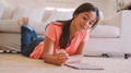 Young Girl Lying On Floor in Lounge At Home Drawing With Stylus On Digital Tablet - PhotoDune Item for Sale