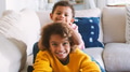 Brother And Sister Lying On Sofa At Home Watching TV Together - PhotoDune Item for Sale