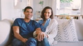 Portrait Of Loving Couple Sitting On Sofa At Home Together - PhotoDune Item for Sale