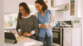Mature Mother And Adult Daughter Prepare Meal In Kitchen Following Recipe On Digital Tablet - PhotoDune Item for Sale