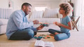 Grandfather And Granddaughter Sitting On Floor in Lounge At Home Building Construction Kit Together - PhotoDune Item for Sale