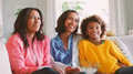 Female Multi Generation Family Sitting On Sofa At Home With Popcorn Watching TV Together - PhotoDune Item for Sale