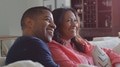 Mature Couple Sitting On Sofa At Home Watching TV Together - PhotoDune Item for Sale