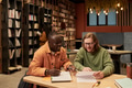 Young Man and Black Man Studying Together in Library - PhotoDune Item for Sale