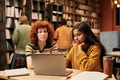 Young Woman and Young Black Woman Studying Together Using Laptop - PhotoDune Item for Sale