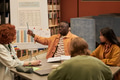 Young Black Man Explaining English Grammar Chart to Diverse Students - PhotoDune Item for Sale