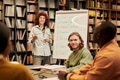 Young Woman Teaching Multiethnic People during Language Class - PhotoDune Item for Sale