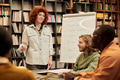 Young Woman Teaching Diverse Group of Young People in Classroom - PhotoDune Item for Sale