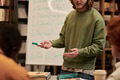 Young Man Explaining Lesson to Diverse Group in Classroom Setting - PhotoDune Item for Sale