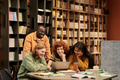Diverse Group of Young People Collaborating on Project in Library Setting - PhotoDune Item for Sale