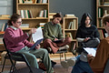 Diverse Teenagers Engaging in Group Therapy Discussion and Completing Worksheets - PhotoDune Item for Sale