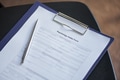 Psychology Intake Form and Pen Resting on Table during Group Therapy Session - PhotoDune Item for Sale