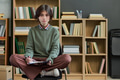 Portrait of Teenager Sitting Cross Legged Participating in Group Therapy - PhotoDune Item for Sale
