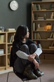 Young Asian Woman Sitting Contemplating during Group Therapy Session Indoors - PhotoDune Item for Sale