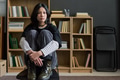 Portrait of Young Asian Woman Sitting Contemplating during Group Therapy - PhotoDune Item for Sale