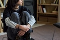 Teenage Girl Sitting Cross Legged during Group Therapy Session Indoors - PhotoDune Item for Sale