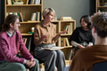 Adult Woman Facilitating Discussion among Diverse Young People - PhotoDune Item for Sale