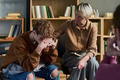 Teenager Sitting with Head down Comforted by Adult Woman - PhotoDune Item for Sale