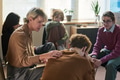 Female Therapist Comforting Distressed Teenager during Group Therapy - PhotoDune Item for Sale