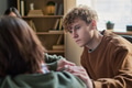 Teenage Boy Comforting Peer during Group Therapy Session Indoors - PhotoDune Item for Sale