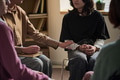 Adult Woman Offering Reassurance to Teenager during Group Therapy - PhotoDune Item for Sale
