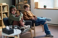 Two Young People Sitting Apart during Group Therapy Session in Counseling Room - PhotoDune Item for Sale