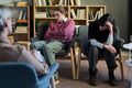 Two Young Women Participating in Group Therapy Session Indoors - PhotoDune Item for Sale