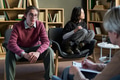 Young Man and Asian Woman Engaging in Group Therapy Discussion - PhotoDune Item for Sale