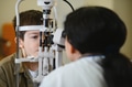 Ophthalmologist examining child's vision with modern equipment in clinic - PhotoDune Item for Sale