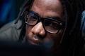 Young Black Man Wearing Glasses Concentrating While Using Computer - PhotoDune Item for Sale