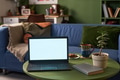 Laptop Displaying Blank Screen on Table in Cozy Living Room Setting - PhotoDune Item for Sale