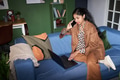 Young South Asian Woman Talking on Smartphone While Using Laptop - PhotoDune Item for Sale